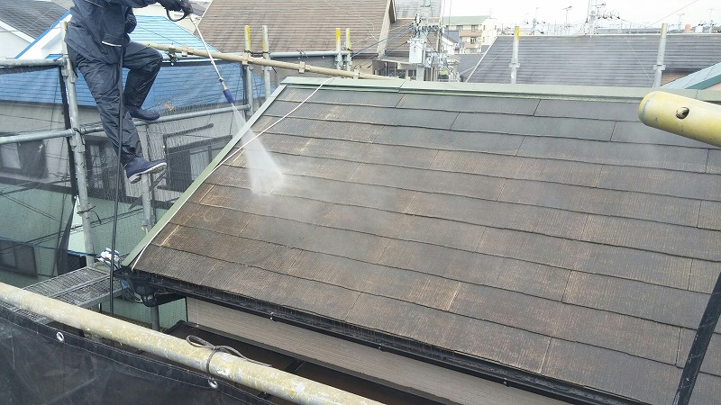 羽曳野市のお客様宅の勾配のキツイスレート屋根洗浄作業の様子。